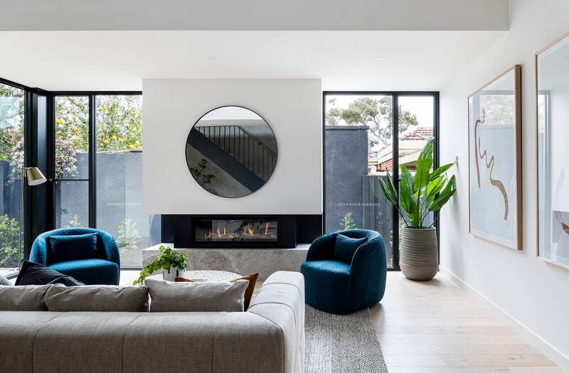 27 central ave beaumaris small lounge room, looking over couch and at the mirror, fireplace and out the windows