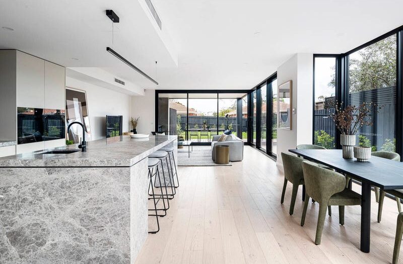 27 central ave black rock stone island bench and dining room table, looking out toward the living/lounge room and sliding doors to the outdoor area