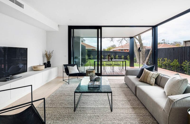 27 central ave black rock lounge room with large couch leaning onto the backyard and outdoor area through large sliding doors