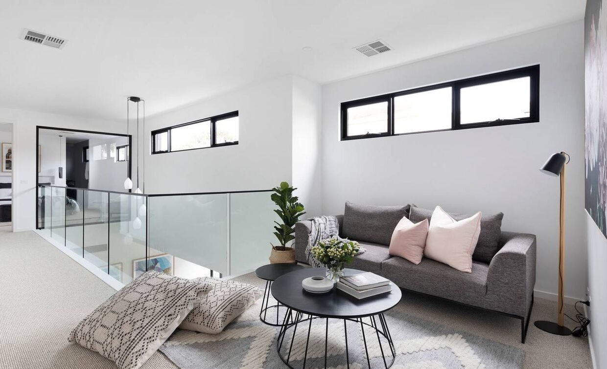 upper level lounge room, with small couch and coffee table, perfect as a reading area