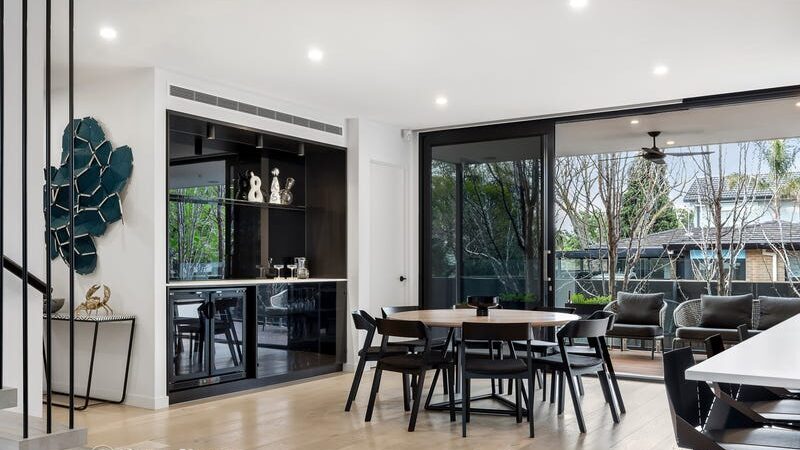 66 thomas st brighton east dining table with bar fridge and mini bar, sliding doors opening onto an outdoor area