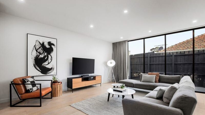 66 thomas st brighton east lounge room with the large L shaped lounge room, swirling artwork
