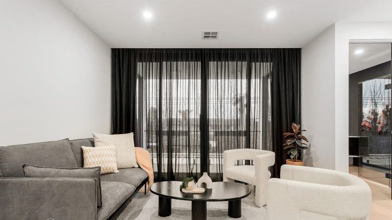 66 thomas st brighton east living area with small couch and two arm chairs and a coffee table