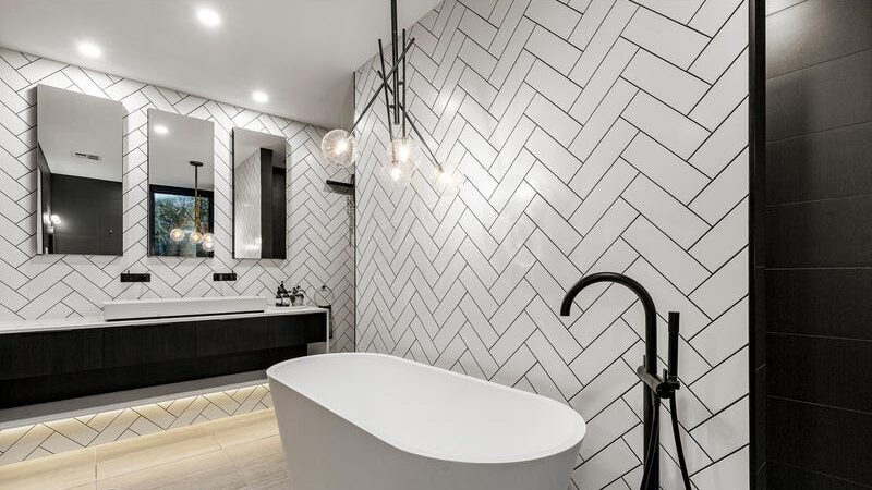 66 thomas st brighton east feature tiled bathroom, with bath tub, hanging light over bathtub, double sink with three rectangular mirrors